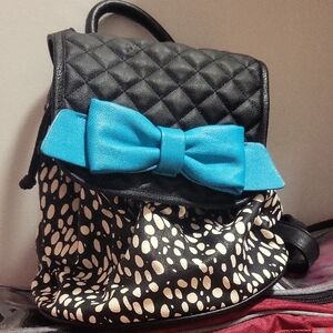 Black Quilted Backpack with Blue Bow